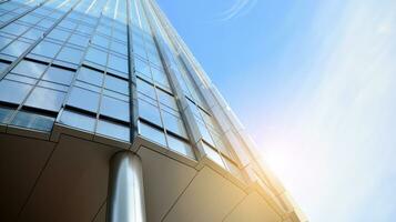 Modern office building with glass facade on a clear sky background. Transparent glass wall of office building. photo