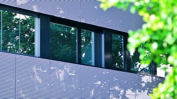 Modern residential building with new apartments in a green residential area. Eco architecture. Green tree and new apartment building. The harmony of nature and modernity. photo