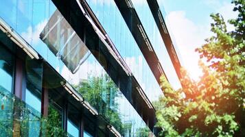 Modern residential building with new apartments in a green residential area. Eco architecture. Green tree and new apartment building. The harmony of nature and modernity. photo