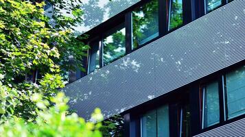 Modern residential building with new apartments in a green residential area. Eco architecture. Green tree and new apartment building. The harmony of nature and modernity. photo