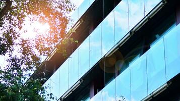 Modern residential building with new apartments in a green residential area. Eco architecture. Green tree and new apartment building. The harmony of nature and modernity. photo
