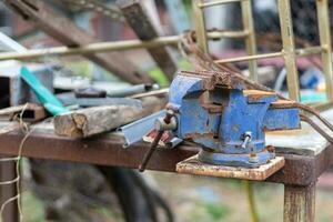 Old hand tools that are placed outdoors without people using them until they rust. photo