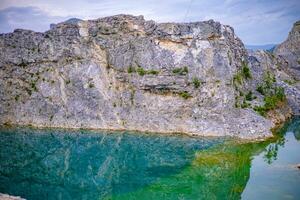 Beautiful rocky mountains and green ponds photo