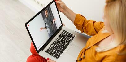 Close-up Of Businesswoman Video Conferencing With Colleague On Laptop photo