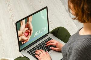 Doctor entering patient notes on a laptop in surgery photo