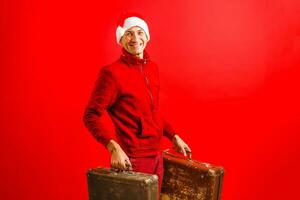 Christmas, tourist trip concept. Santa Claus with suitcases is going to travel around the planet. Christmas time. Time for miracles. Copy space. photo