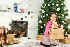 Little girl decorating the Christmas tree photo