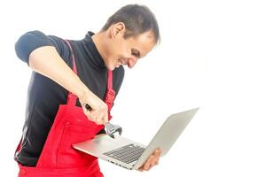 Portrait of a furious man with a hammer about to destroy his monitor - isolated on white photo