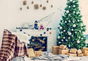 Fireplace and Christmas tree with presents in living room photo