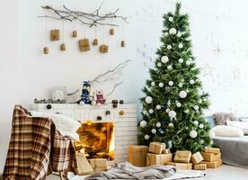 Fireplace and Christmas tree with presents in living room photo