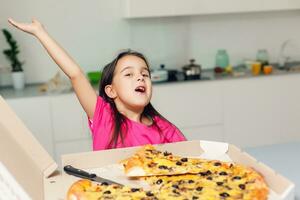 little girl with big pizza at home photo