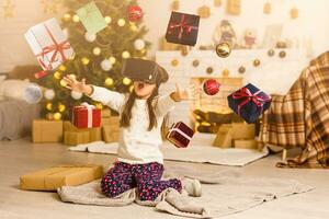 little girl in virtual 3D glasses at christmas at home photo