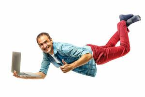 Young hipster man with laptop in the air. isolated on white. Concept communication. photo