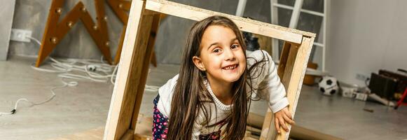 girl, child builds, repairs booth, house for dog photo