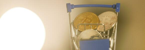 Shop trolley for purchases with bitcoins. Crypto currency bitcoin on a black background. Empty space for text. photo