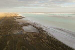 Salt lake with wide flatlands background. photo