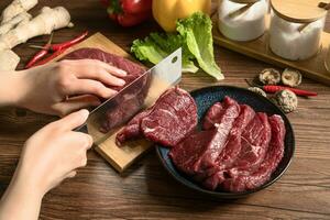 Raw beef with wooden table background photo