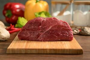 Raw beef with wooden table background photo