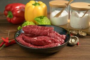 Raw beef with wooden table background photo