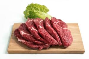 Freshness raw beef in pieces on the cutting board with white background. photo