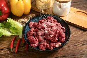 Raw beef with wooden table background photo