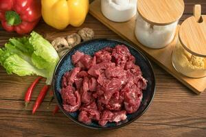 Raw beef with wooden table background photo