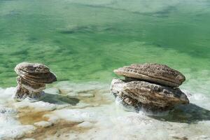 Salt stones by the green saline lake. photo