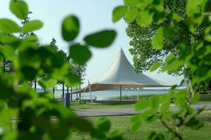 A sailboat tent by the lake, public park scenery. photo