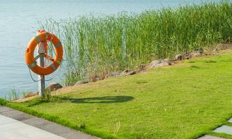 The life buoy by the lake in a public park. photo