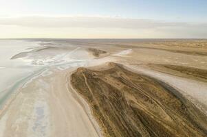 Salt lake with wide flatlands background. photo