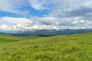 Grassland and mountains in a sunny day. Photo in Kalajun grassland in Xinjiang, China.