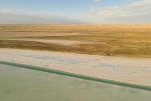 Salt lake with wide flatlands background. photo