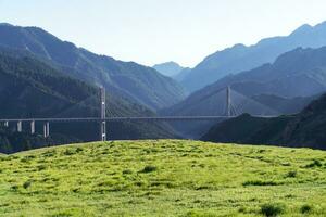 The bridge between the mountains. Guozigou Bridge in Xinjiang, China. photo