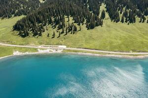 Lake and grassland with a sunny day. Shot in Sayram Lake in Xinjiang, China. photo