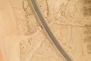 Dryness land with erosion terrain with highway crossing. photo