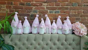 A group of Christmas stuffed elf toys isolated on a gray background photo