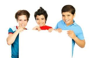 Happy schoolboys with white board photo