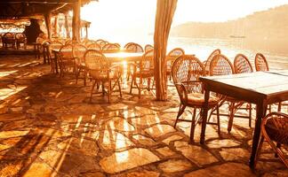 Seaside cafe in sunset light photo