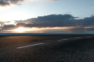 The empty Asphalt road and daylight sky and sunshine. photo