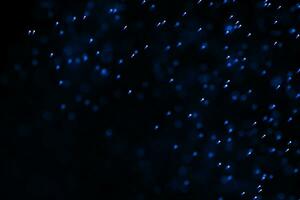 Flowing and glowing particles with dark background, 3d rendering photo