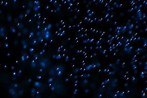 Flowing and glowing particles with dark background, 3d rendering photo