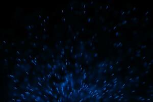 Flowing and glowing particles with dark background, 3d rendering photo