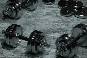 Dumbbells with concrete background, fitness theme, 3d rendeirng. photo