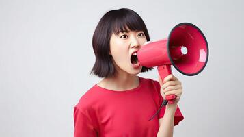 portrait of a young woman screaming with a megaphone against a white background photo