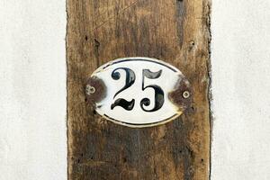 house number twenty-five 25 plaque on wall photo
