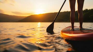 Person on SUP standup paddle board paddling into sunset on lake. Generative AI. photo