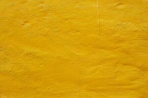 rough plaster wall painted bright yellow background photo