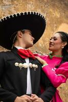 young hispanic woman and man in independence day or cinco de mayo parade or cultural Festival photo