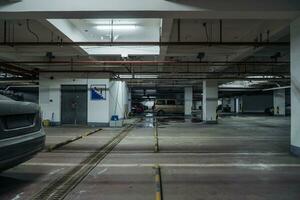 old parking lot with lighting, concrete building photo