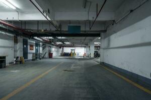 old parking lot with lighting, concrete building photo